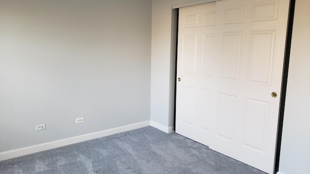unfurnished bedroom with carpet flooring and baseboards