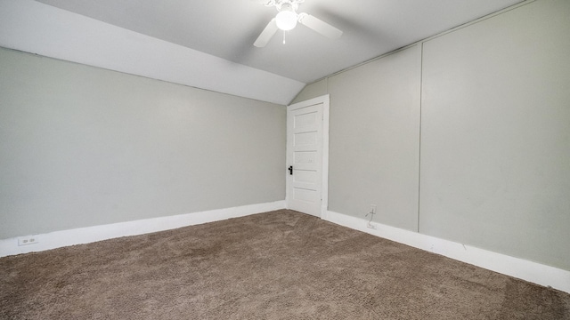 carpeted empty room with ceiling fan, baseboards, and lofted ceiling