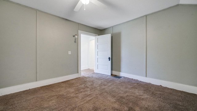carpeted empty room featuring visible vents and ceiling fan