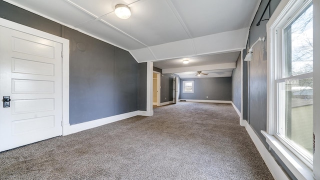 interior space with carpet flooring, ceiling fan, and baseboards