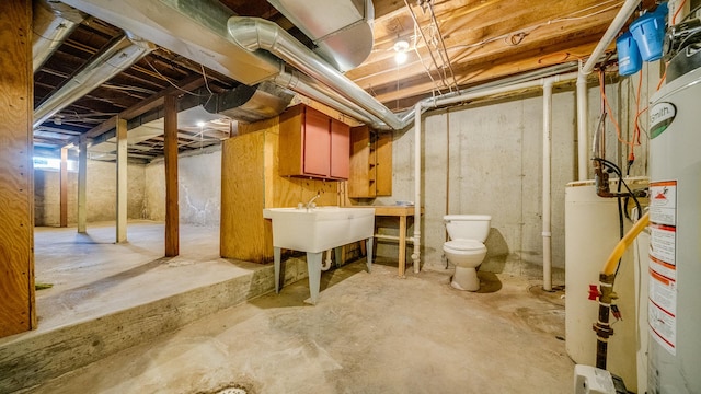 unfinished below grade area with a sink and gas water heater