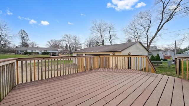 deck with a garage and a lawn