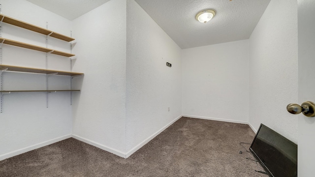 interior space featuring a textured ceiling and baseboards