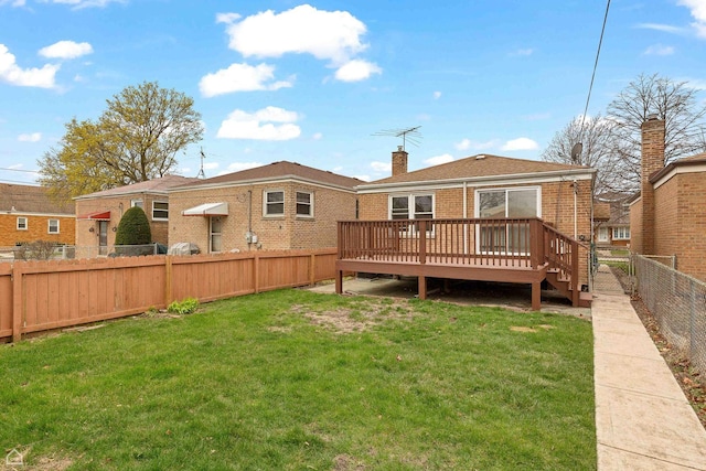 5753 S Moody Ave, Chicago, IL 60638 - rear view of house featuring a chimney, brick siding, a fenced backyard, a wooden deck, and a lawn