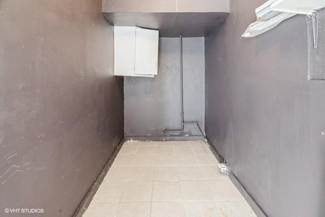 unfinished basement featuring light tile patterned floors