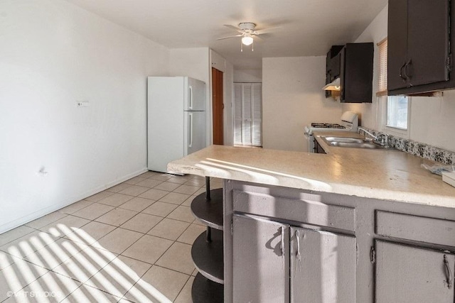 kitchen with exhaust hood, a sink, light countertops, a ceiling fan, and white appliances