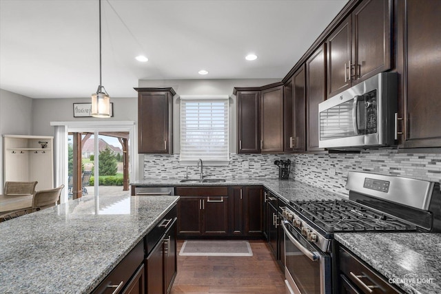 6625 Savanna Ln, Lakewood, IL 60014 - kitchen with a sink, dark wood-style flooring, stainless steel appliances, backsplash, and stone countertops