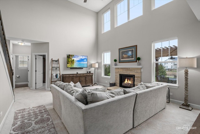6625 Savanna Ln, Lakewood, IL 60014 - living area with a fireplace, a towering ceiling, light colored carpet, and baseboards