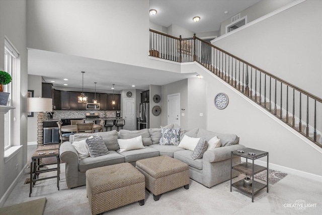 6625 Savanna Ln, Lakewood, IL 60014 - living room with a high ceiling, baseboards, light carpet, and stairs