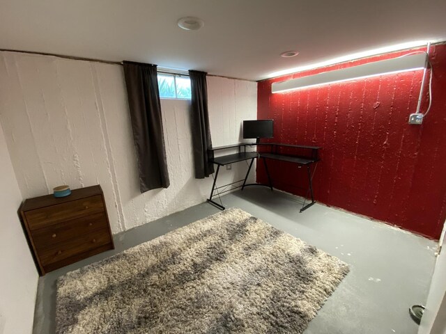 bedroom featuring concrete flooring