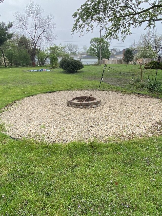 view of yard with a fire pit