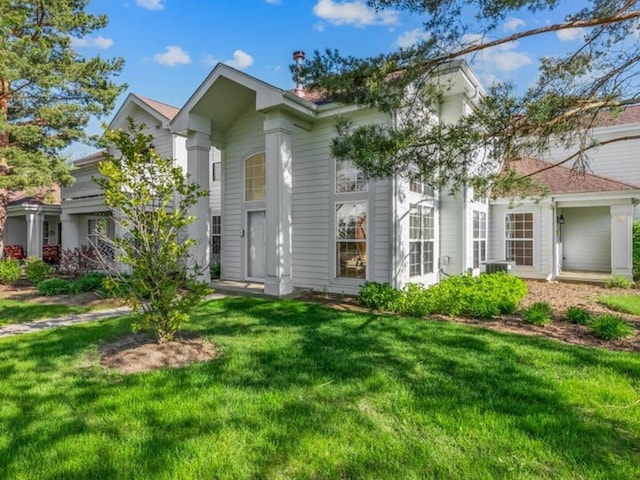 9531 Lenox Ln, Lakewood, IL 60014 - neoclassical home with a front lawn and central AC unit