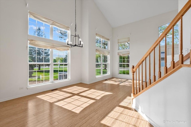 9531 Lenox Ln, Lakewood, IL 60014 - entrance foyer with high vaulted ceiling, a chandelier, stairway, and baseboards