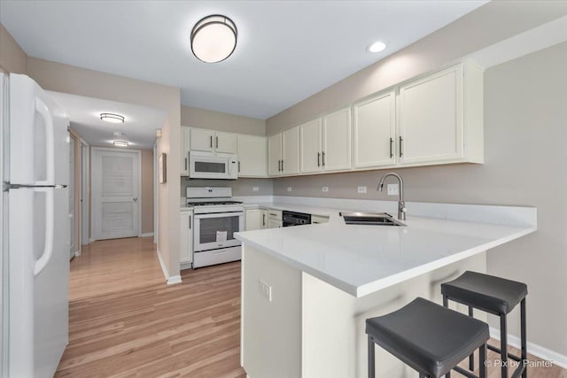 9531 Lenox Ln, Lakewood, IL 60014 - kitchen featuring white appliances, a sink, a peninsula, light countertops, and baseboards