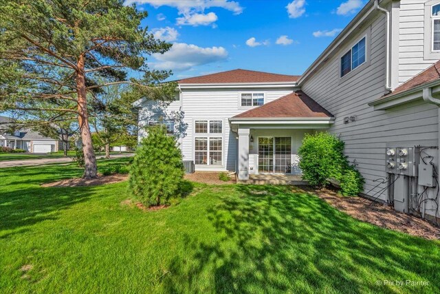 9531 Lenox Ln, Lakewood, IL 60014 - back of house with a lawn, cooling unit, and roof with shingles