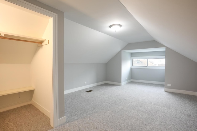 9046 S Racine Ave, Chicago, IL 60620 - additional living space with carpet, visible vents, baseboards, and lofted ceiling