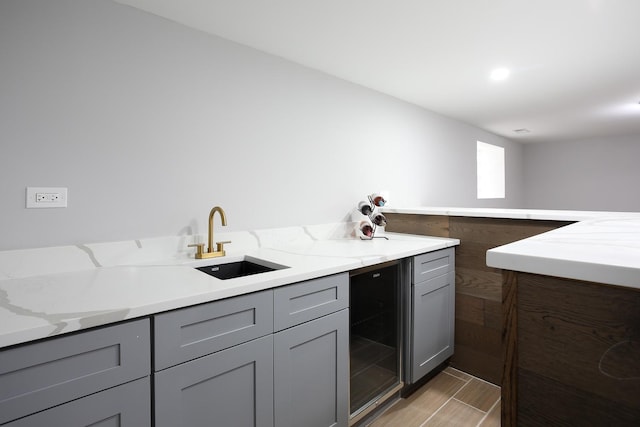 9046 S Racine Ave, Chicago, IL 60620 - kitchen with a sink, gray cabinets, beverage cooler, and light stone counters