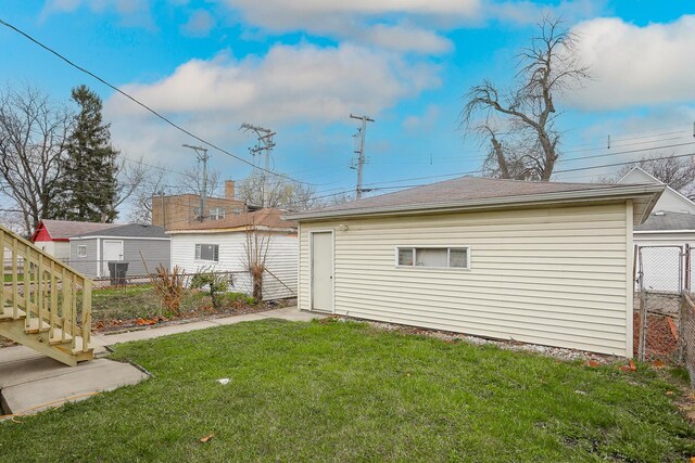 9046 S Racine Ave, Chicago, IL 60620 - back of house featuring an outdoor structure, fence, and a lawn