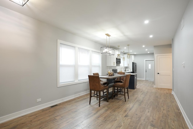 9046 S Racine Ave, Chicago, IL 60620 - dining area with baseboards, light wood-type flooring, and recessed lighting