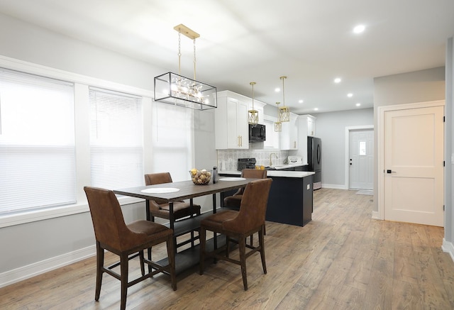 9046 S Racine Ave, Chicago, IL 60620 - dining area with recessed lighting, a notable chandelier, light wood-type flooring, and baseboards
