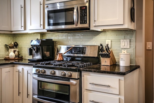 kitchen with backsplash, white cabinets, and stainless steel appliances