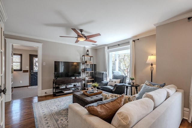 living room featuring dark wood finished floors, plenty of natural light, and a ceiling fan