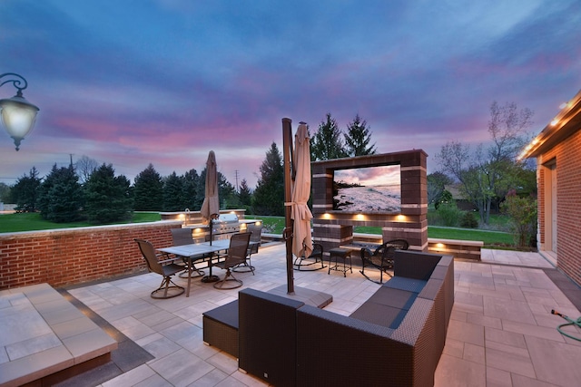 22328 N Prairie Ct, Kildeer, IL 60047 - patio terrace at dusk with outdoor dining area and an outdoor living space with a fireplace