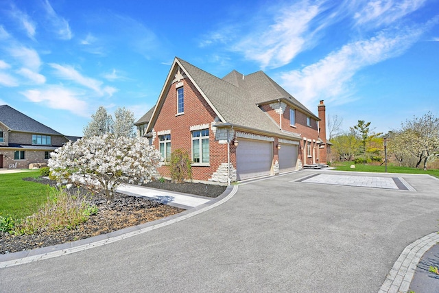 22328 N Prairie Ct, Kildeer, IL 60047 - view of front of house featuring brick siding, an attached garage, asphalt driveway, a shingled roof, and a chimney