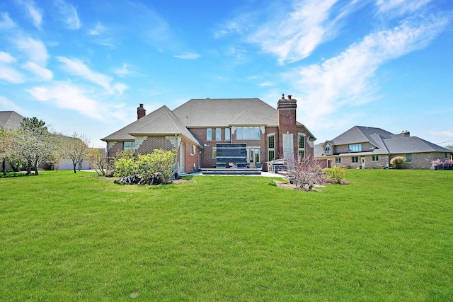 22328 N Prairie Ct, Kildeer, IL 60047 - back of house with a chimney, a lawn, and a patio area