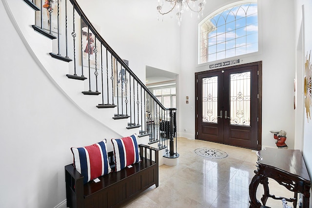 22328 N Prairie Ct, Kildeer, IL 60047 - entryway with a towering ceiling, stairway, french doors, a chandelier, and baseboards