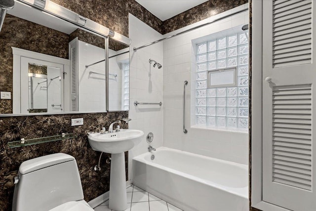 bathroom featuring a closet, toilet, and tub / shower combination