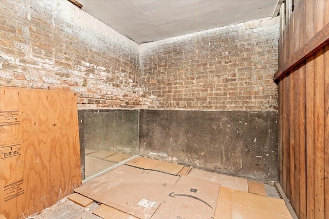 bathroom with brick wall