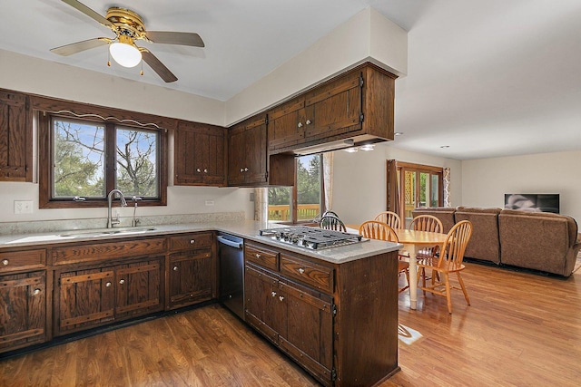 kitchen featuring dark wood-type flooring, a sink, appliances with stainless steel finishes, and light countertops