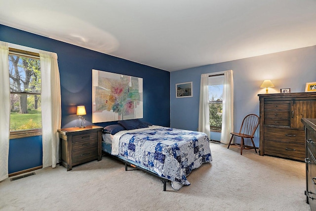 bedroom featuring carpet floors, baseboards, and visible vents