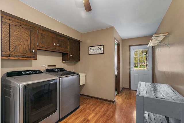 laundry room with washer and dryer, baseboards, ceiling fan, light wood-type flooring, and cabinet space