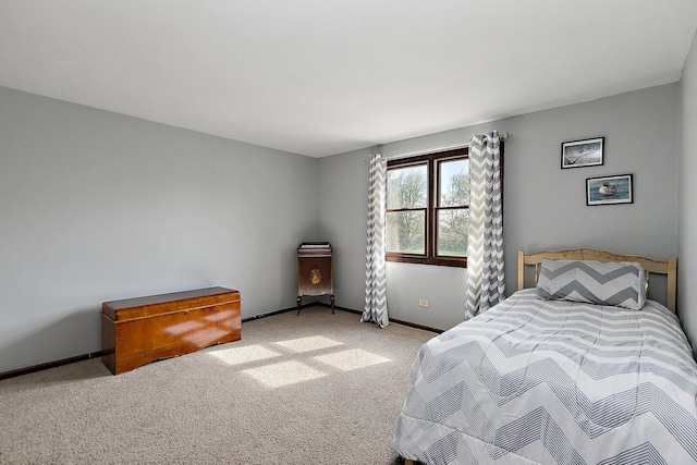bedroom featuring baseboards and light carpet
