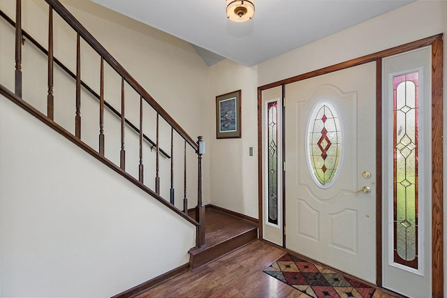 foyer featuring stairway, baseboards, and dark wood-style floors