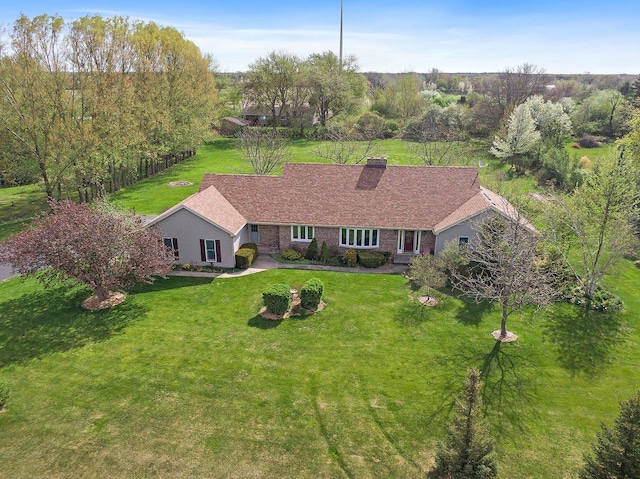 view of front facade with a front lawn and a chimney