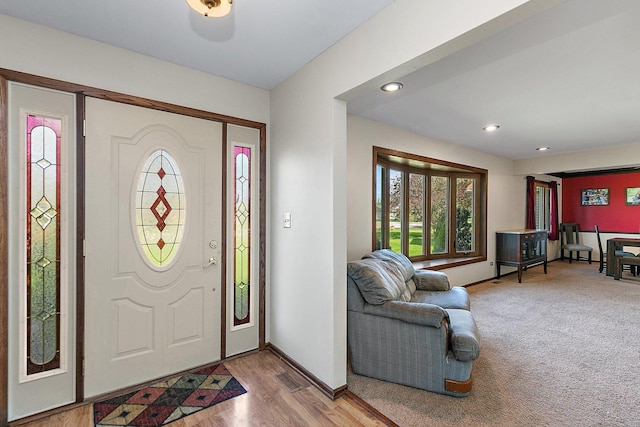 foyer featuring recessed lighting, baseboards, visible vents, and wood finished floors