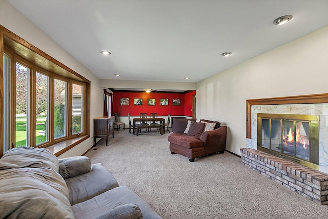 living area with a high end fireplace, carpet floors, and recessed lighting