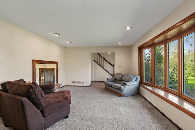 carpeted living room featuring baseboards, recessed lighting, stairs, and visible vents