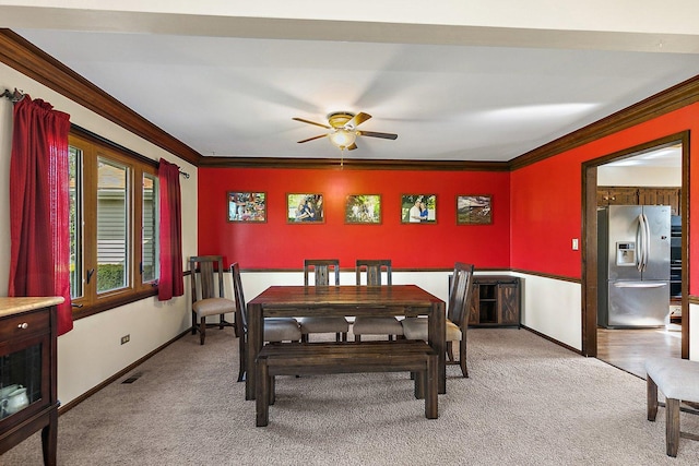 dining area featuring baseboards, ceiling fan, light carpet, and visible vents