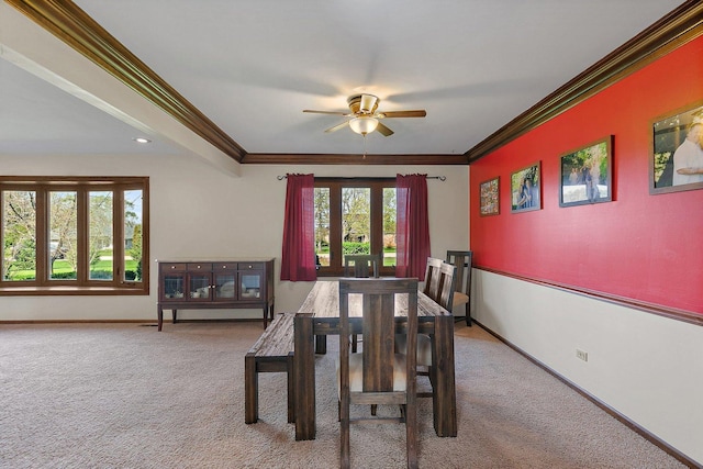 dining room with carpet flooring, crown molding, and baseboards