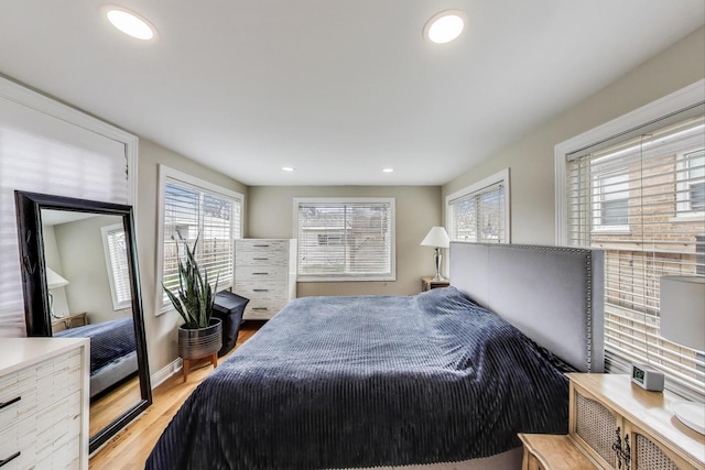 bedroom with wood finished floors and recessed lighting