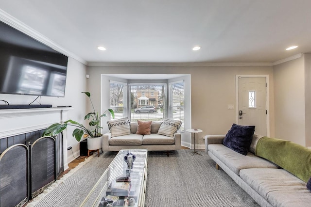 living room featuring wood finished floors, baseboards, recessed lighting, and ornamental molding
