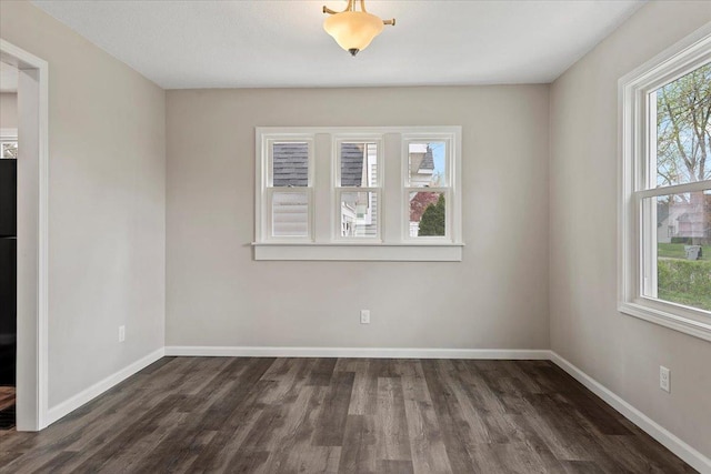 1980 W Forest Ave, Decatur, IL 62522 - unfurnished room featuring baseboards, wood finished floors, and a healthy amount of sunlight