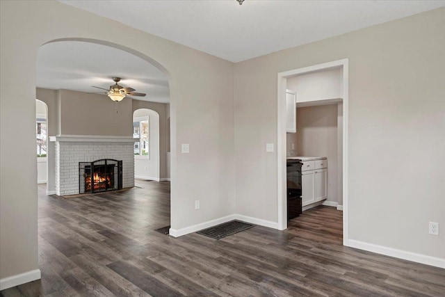 1980 W Forest Ave, Decatur, IL 62522 - unfurnished living room featuring dark wood-type flooring, ceiling fan, and baseboards