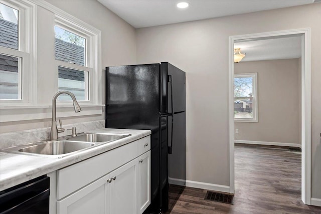 1980 W Forest Ave, Decatur, IL 62522 - kitchen featuring white cabinetry, black appliances, a sink, baseboards, and plenty of natural light