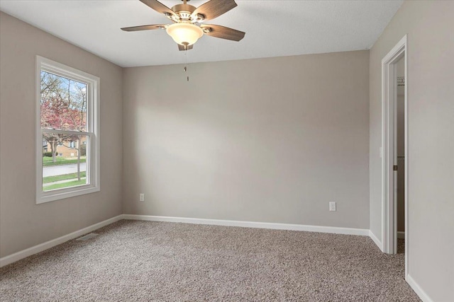 1980 W Forest Ave, Decatur, IL 62522 - empty room with a wealth of natural light, baseboards, and carpet floors