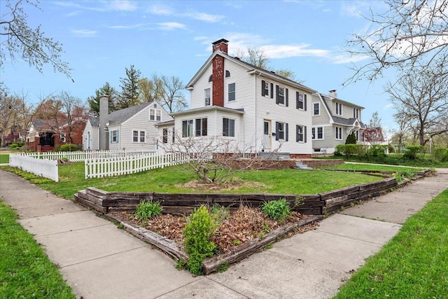 1980 W Forest Ave, Decatur, IL 62522 - view of front of house with a chimney, a front yard, and fence